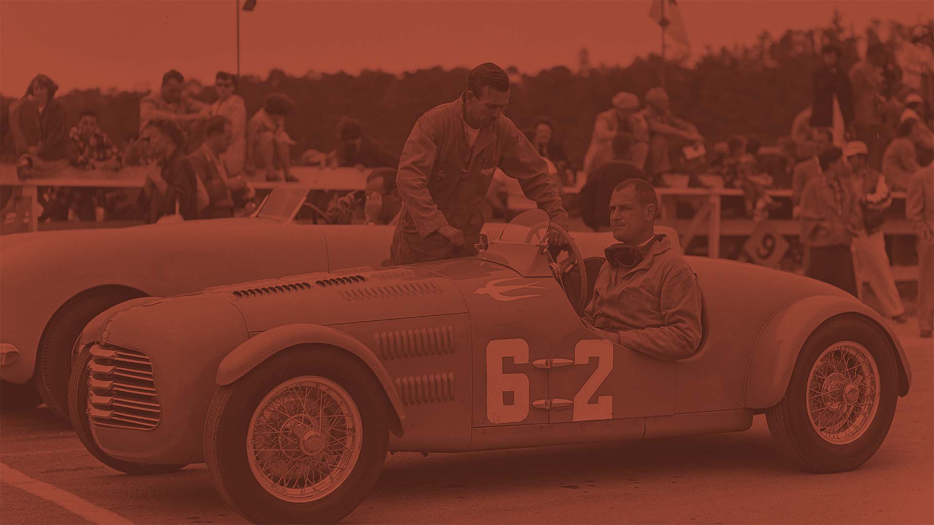 Vintage race car with number 6-2 at a racing event.