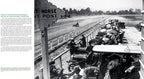 Vintage black and white photograph of an early automotive race with spectators and cars on a track.